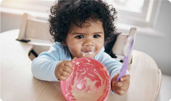 Baby with utensils