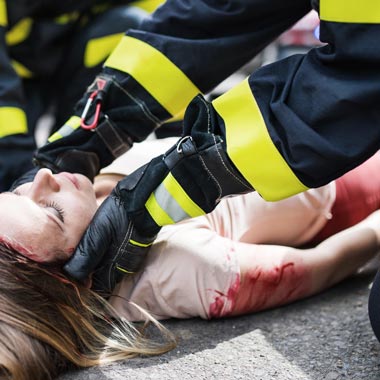 Paramedic treating bleeding casualty
