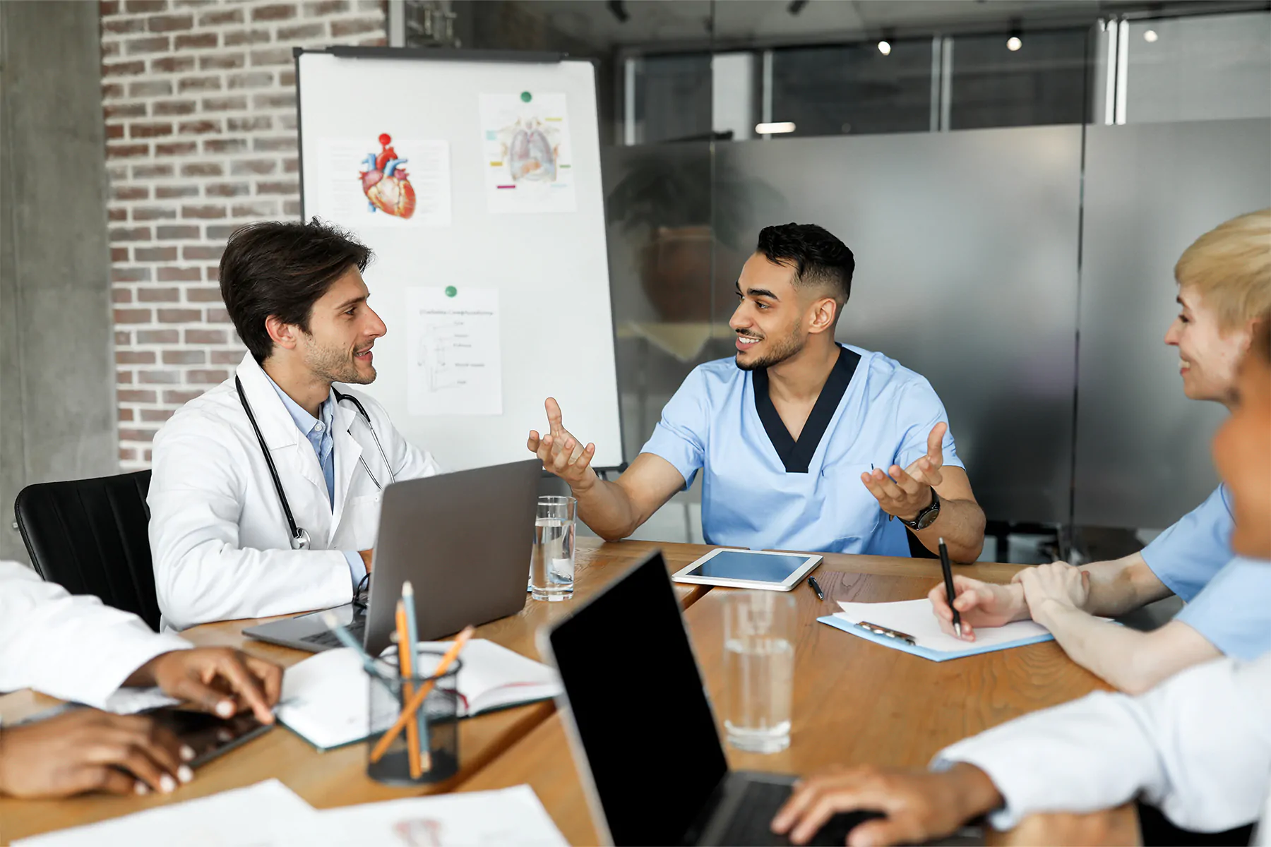 Cheerful doctors multiracial team having briefing, discussing cases