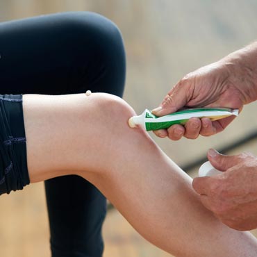 Sports therapist applying ointment