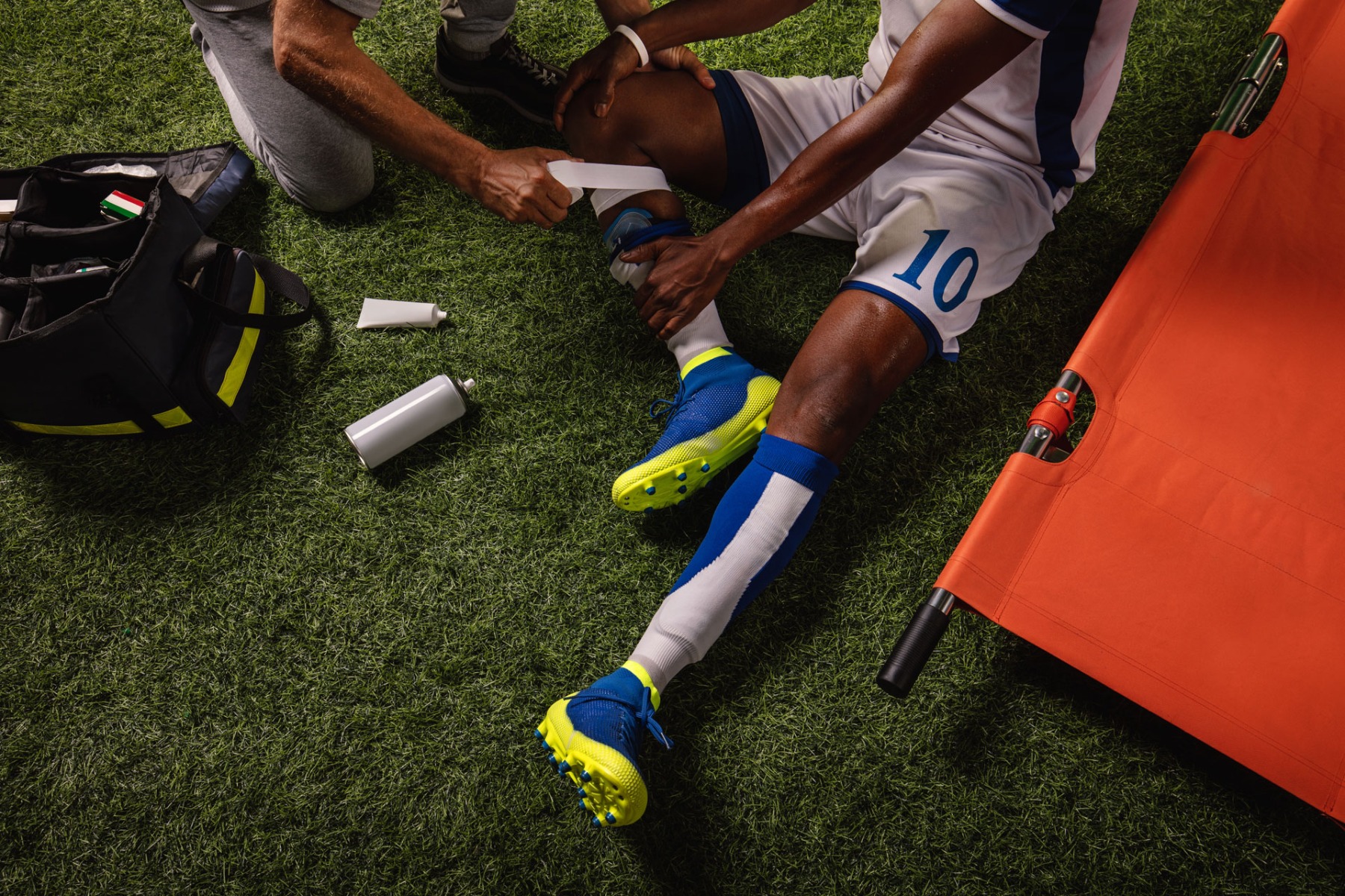 Footballer being treated for leg injury with bandage