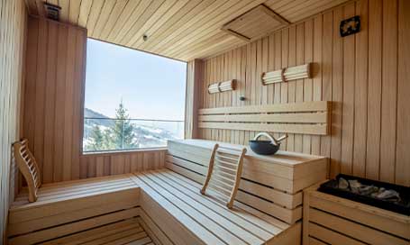 Empty wooden sauna room with traditional sauna accessories