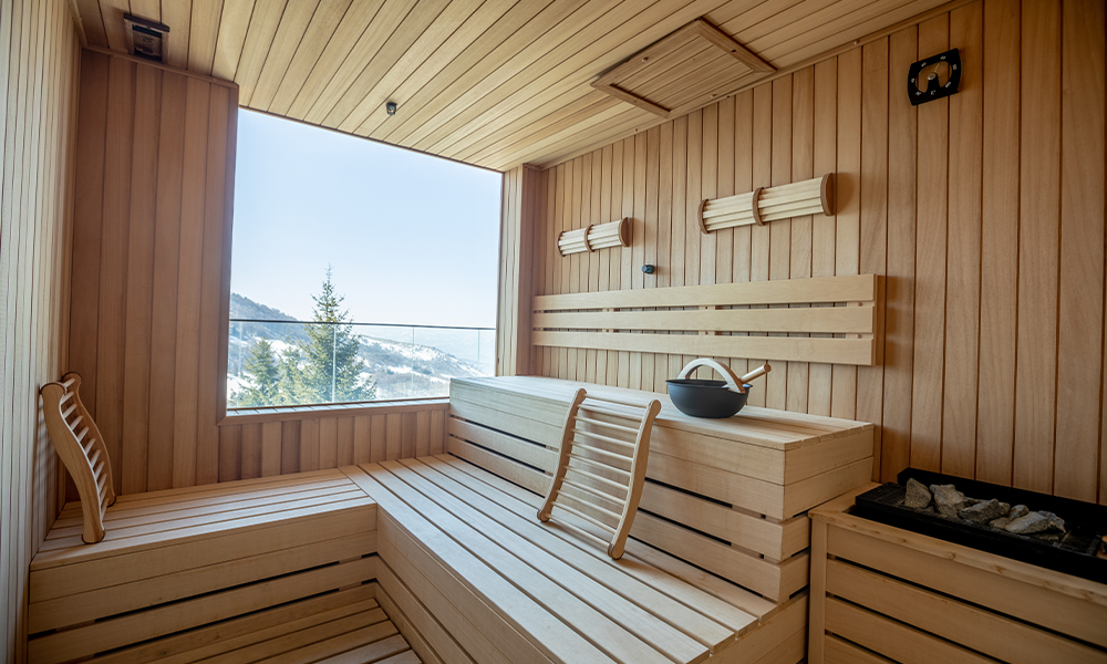 Empty wooden sauna room with traditional sauna accessories