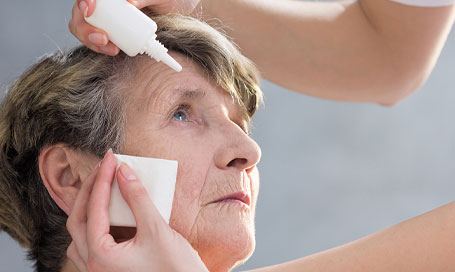 eyedrops being dropped into a patient’s eye