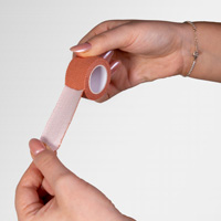 Someone peeling fabric strapping tape