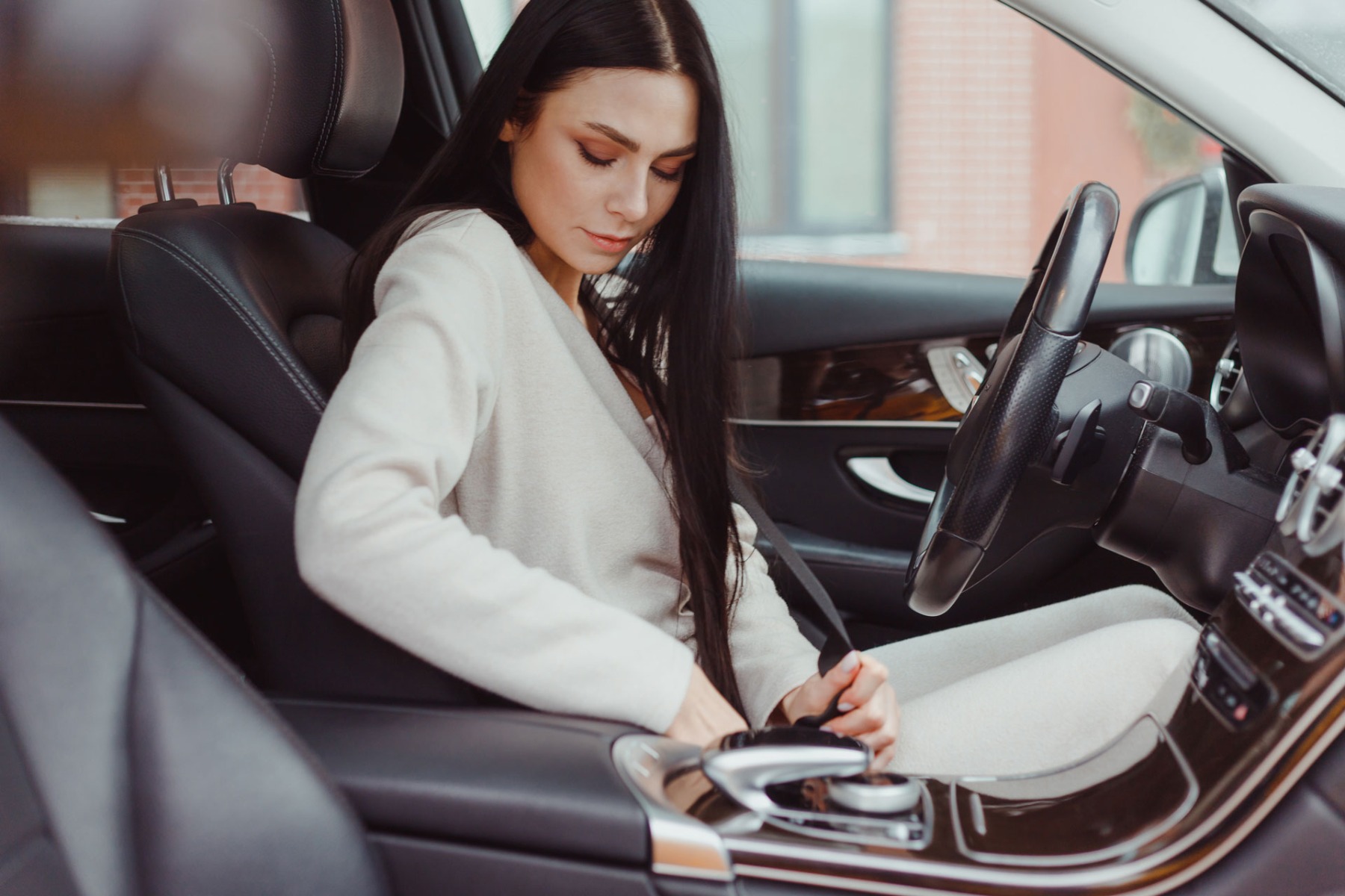 Female Driver In Car Fastening Seatbelt