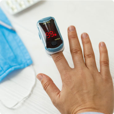 C19 Finger Tip Pulse Oximeter being used on someones finger