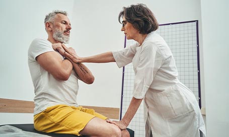 Focused osteopath assessing the patient physical fitness