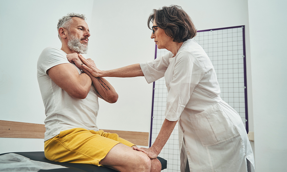 Focused osteopath assessing the patient physical fitness