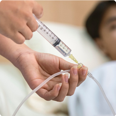 Nurse administering IV fluid with a Luer Slip Tip IV Syringe