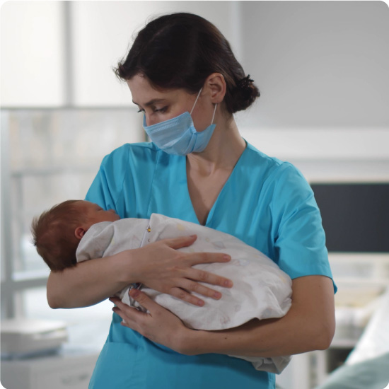 Nurse holding newborn baby