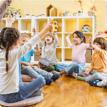 Young children sat on the floor in a nursery
