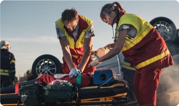 Paramedic performing CPR on car crash victim