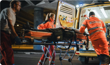 Paramedics transferring patient onto an ambulance on a stretcher