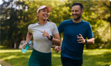A man and woman running together in the park