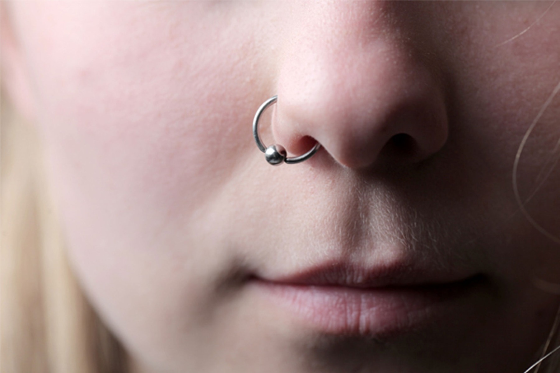 Woman with nose piercing how to wash a piercing