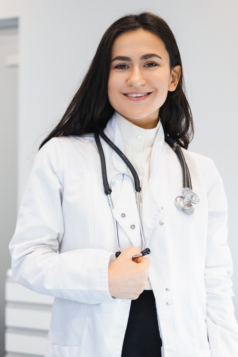 Portrait of happy female doctor with stethoscope in office