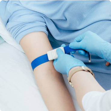 Partial view of doctor using tourniquet for blood test in hospital