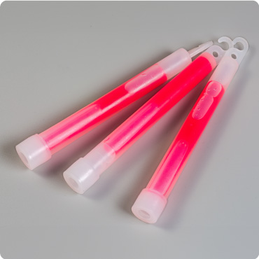 Three red lightsticks on a grey surface