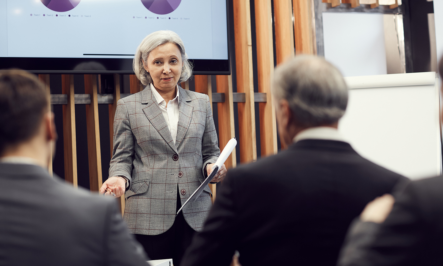 Senior financial director of company giving speech at meeting