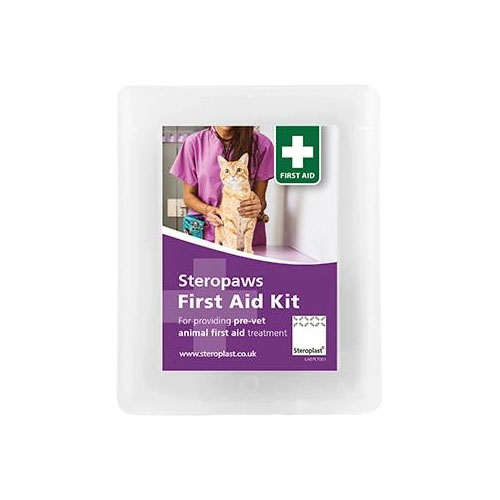 Contents of a Stero-paws First Aid Kit laid out, including blue gloves, bandages, scissors, antiseptic wipes, tape, and a Tick Twister tool, alongside the kit's white case.