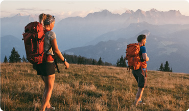 A man and woman hiking up a mountain