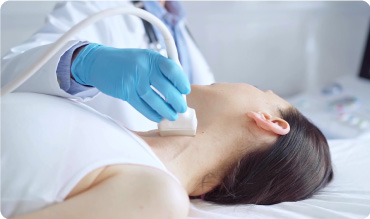 Doctor conducting an ultrasound scan on a patients neck