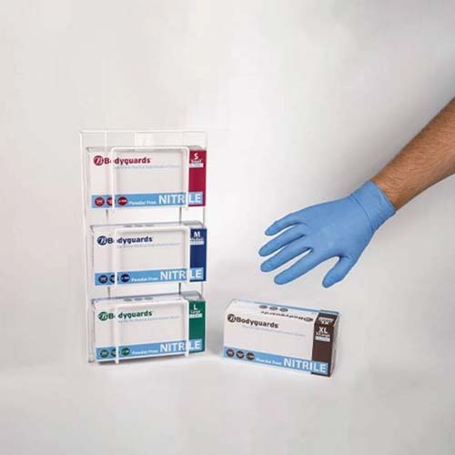 A display stand holding multiple sizes of nitrile gloves, with a hand reaching for a blue glove.