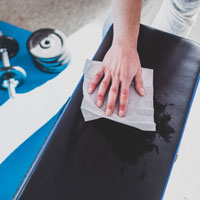 Someone Wiping a gym bench