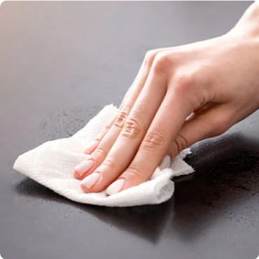 Someone using santising wipe to clean surface