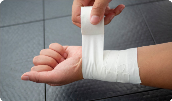 Zinc Oxide Tape protecting wound on arm