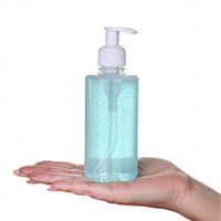 A generic transparent bottle of hand sanitiser with a white pump dispenser and a blank white label, placed against a plain white background.