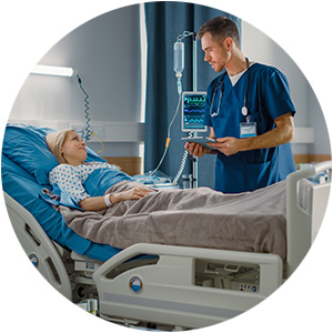 Nurse attending to a patient in a hospital bed