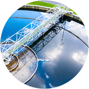 Industrial water treatment facility with reflective water and machinery.